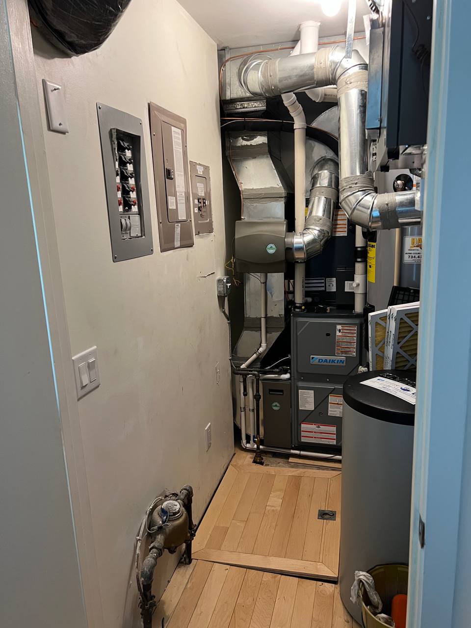 Utility room packed with mechanical equipment and electrical panels